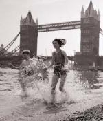 Children paddling on the foreshore below Tower Bridge